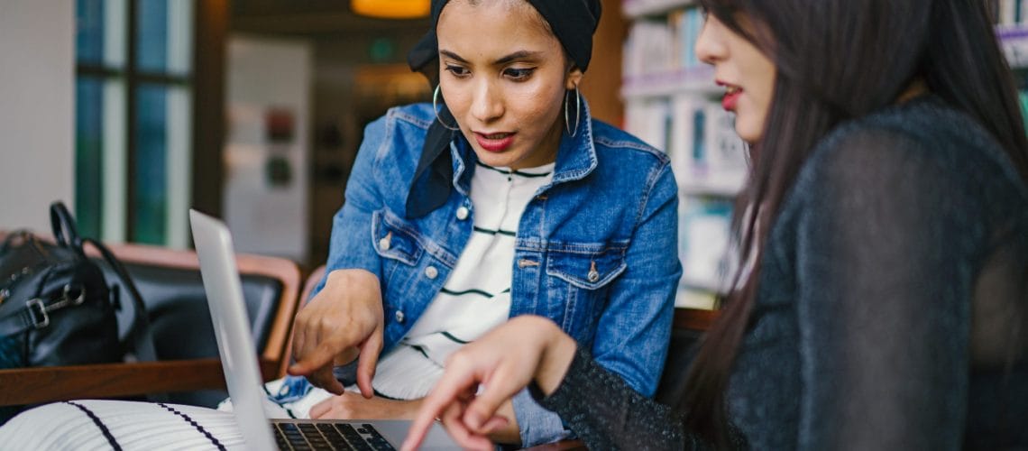 Two Women Meeting Laptop Data Integration Nonprofits Need A Data Integration Solution